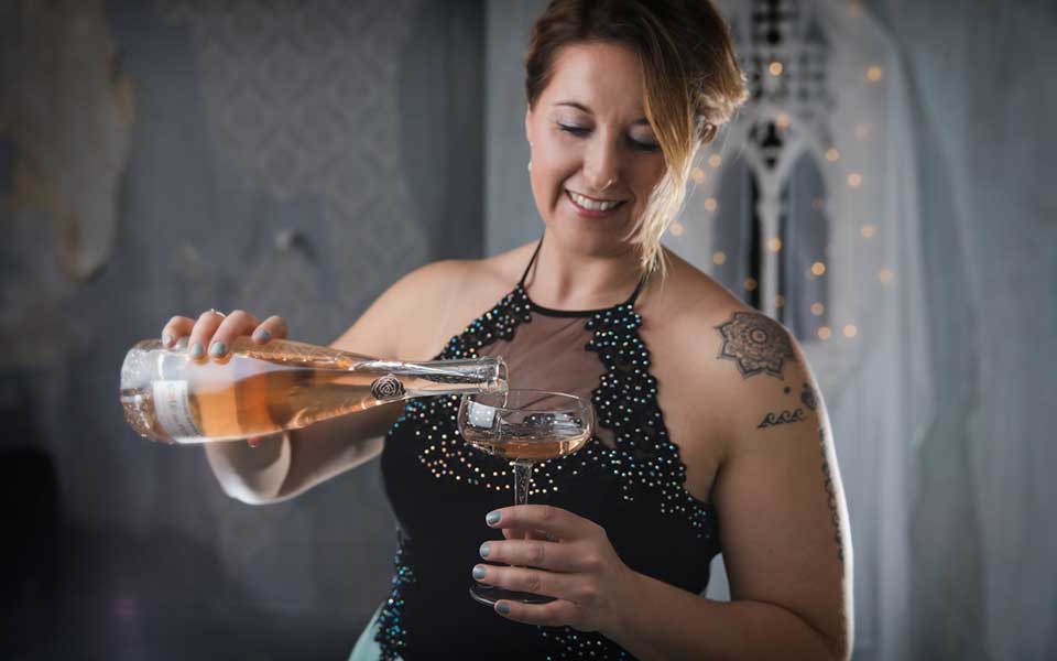 Leigh Clements of Shot In The Dark Mysteries pouring champagne