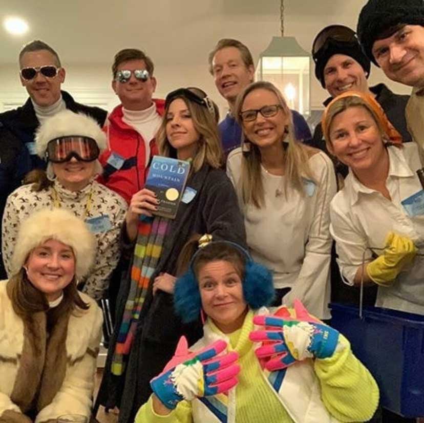 A Murder in the Alps mystery party group in ski gear having a party