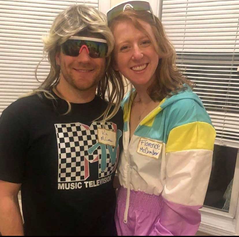 A man and woman dressed for 1980s themed Murder in the Alps Skiing murder mystery party
