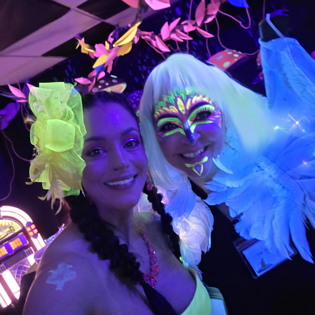 TwoWomenAtAMysteryParty Two women at a Murder in Wonderland Mystery Party Game from Shot In The Dark Mysteries